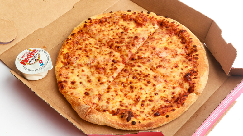 Domino's cheese pizza in box with dipping sauce