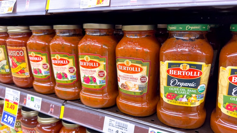 Bertolli pasta sauces lined up on grocery store shelf