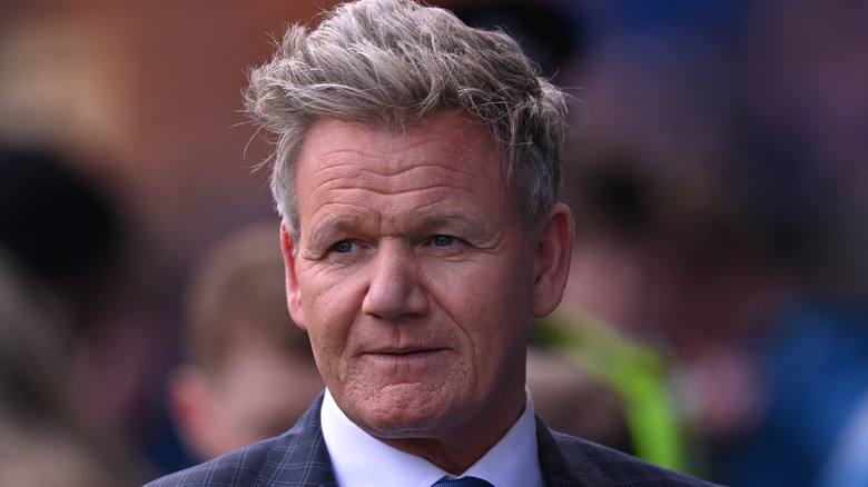 Gordon Ramsay in a suit looking off to one side