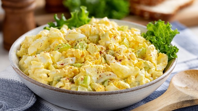 Egg salad in a bowl with lettuce leaves