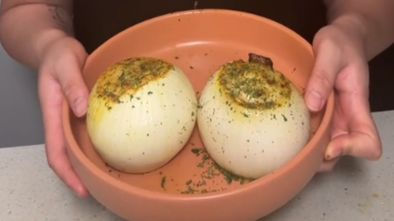 baked whole onions in a clay bowl