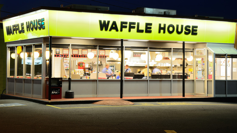 The exterior of a Waffle House location at night