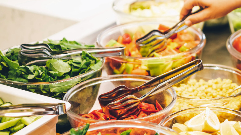 plastic tongs in food bowls