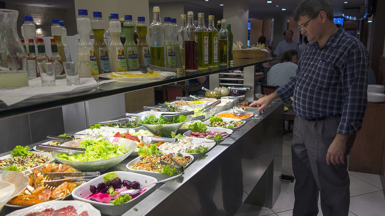 examining vegetables on buffet