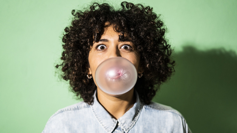 Woman blowing a bubble with her gum