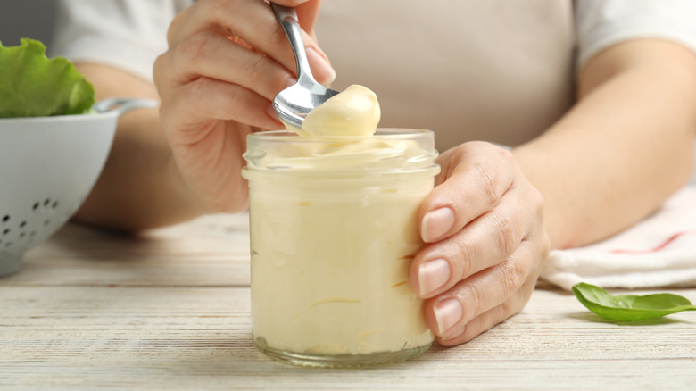 spooning mayo out of a jar