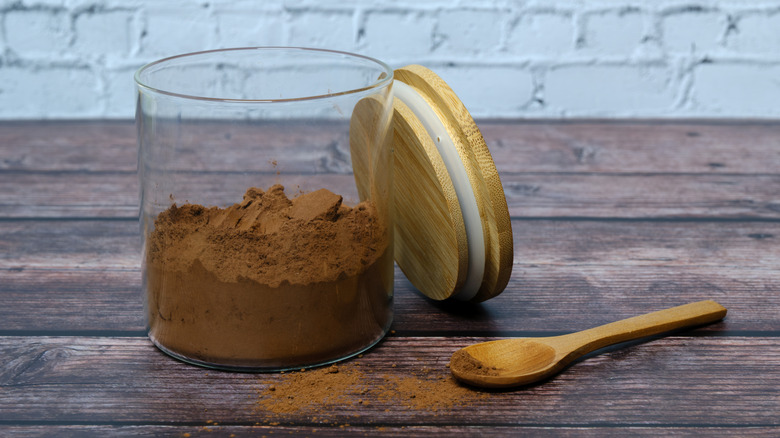 jar of cocoa powder with spoon and lid