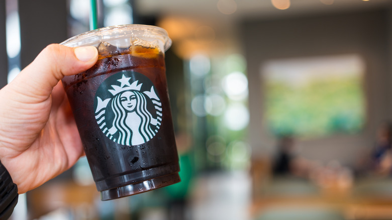 Hand holding Starbucks cold brew