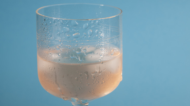 A glass of rose wine with ice cubes