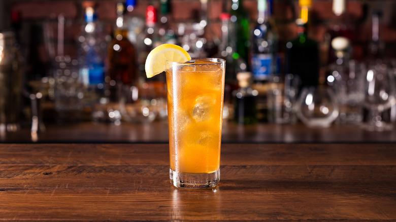 Close-up of tall glass of Long Island iced tea on bar counter