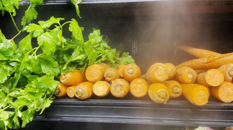 Carrots and lettuce being misted in the produce section