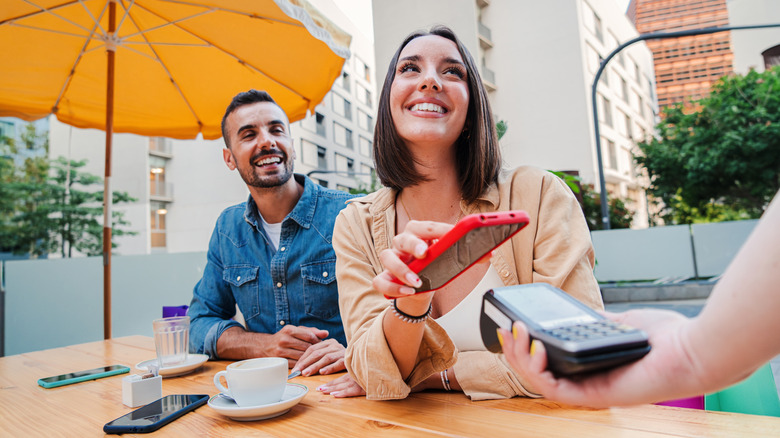 restaurant guests paying for meals