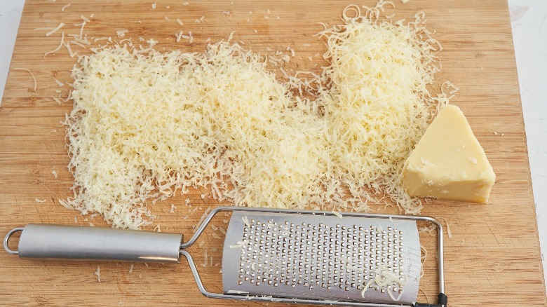 grated gruyere on wooden board