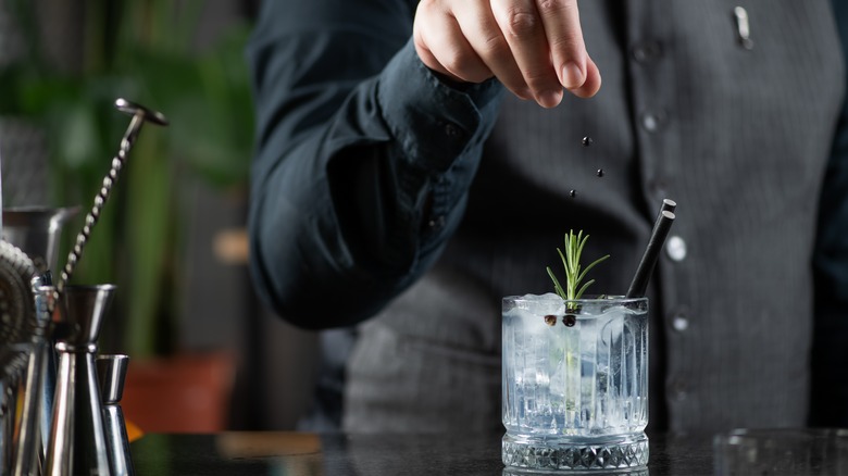 Bartender making gin cocktail