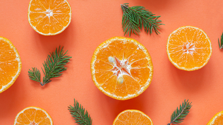 Halved oranges on an orange background.