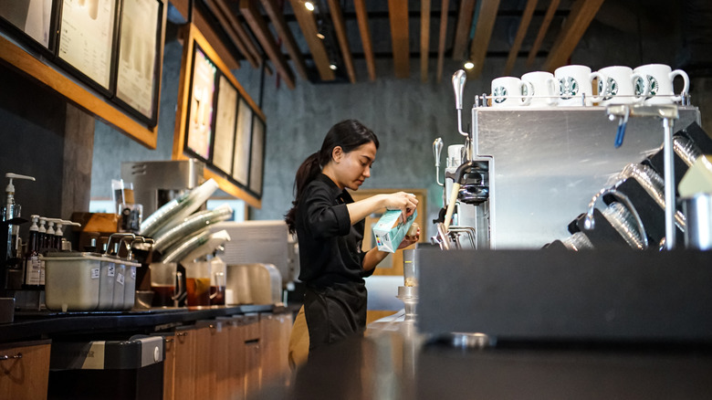 A Starbucks barista making a drink