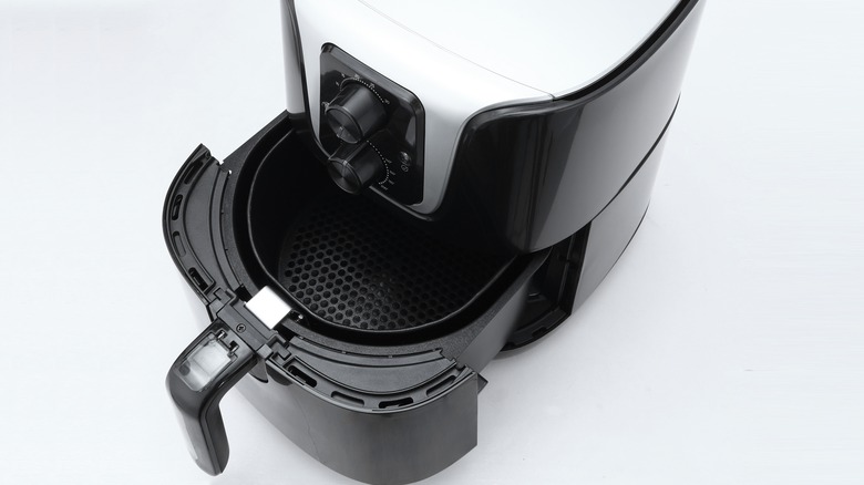 Overhead view of an air fryer with open basket