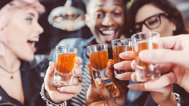 Young people about to take a round of shots