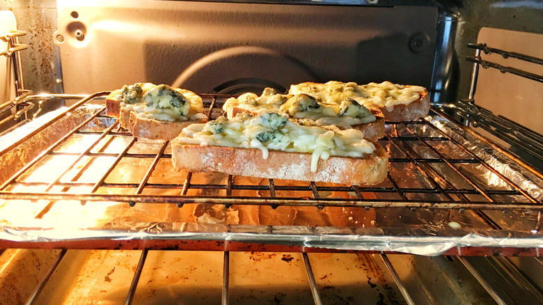 Pizza style bread slices in oven