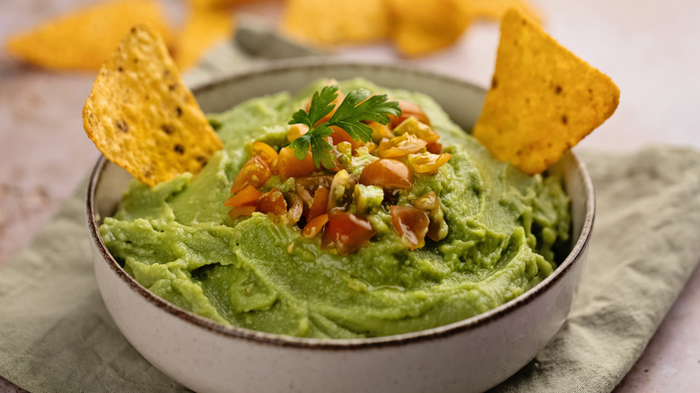 bowl of guacamole with tortilla chips