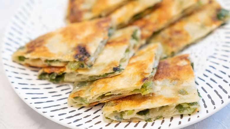 cut scallion pancake on plate