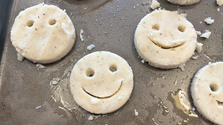 smiling potato circles on a baking sheet