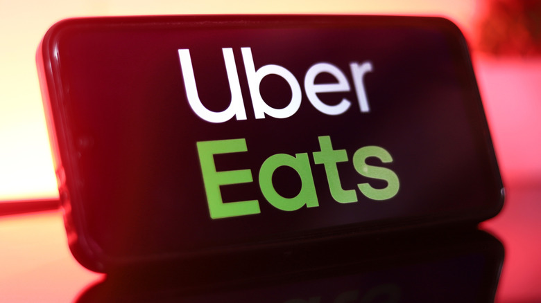 Uber Eats app logo on cell phone display