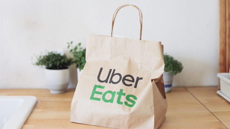 An Uber Eats bag on a wooden table