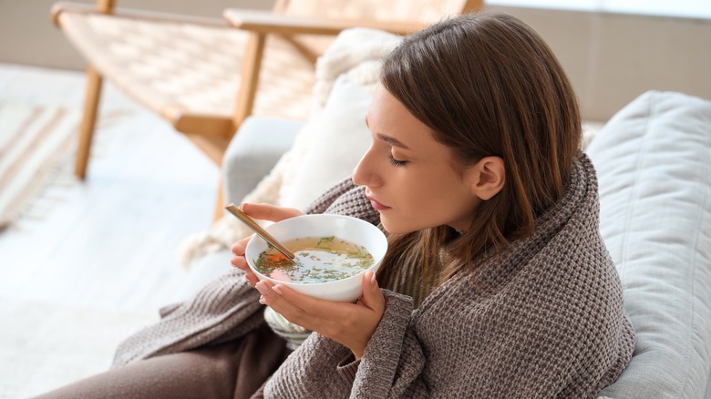 Person with soup on the couch