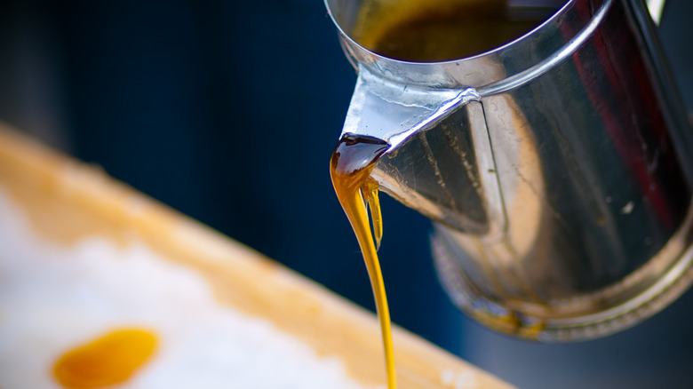 Maple syrup poured from stainless steel spout