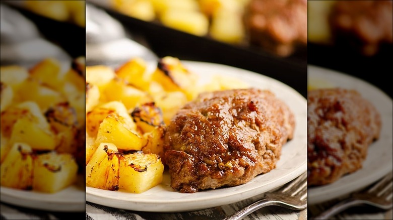 Meatloaf with grilled pineapple on white plate