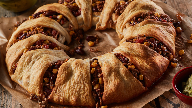 meat crescent roll ring on wooden surface