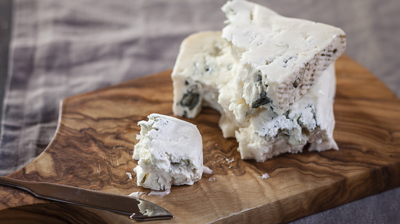 Chunks of blue cheese on a cutting board