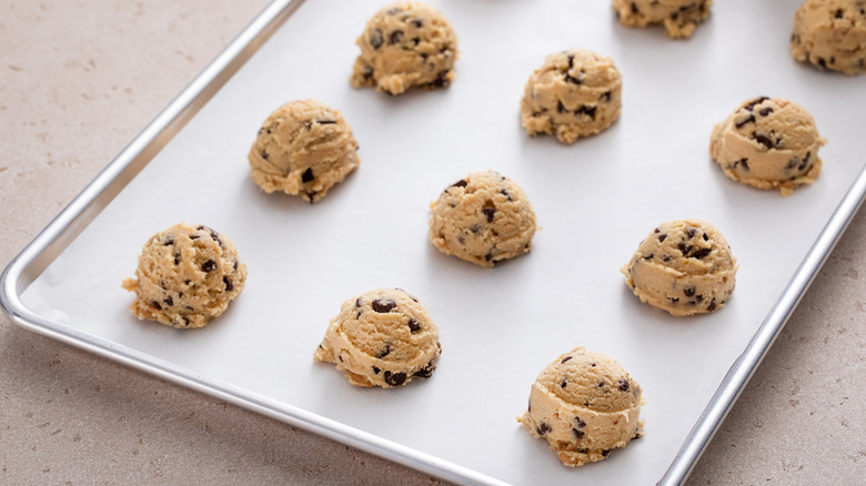 Sheet tray of chocolate chip cookie dough balls