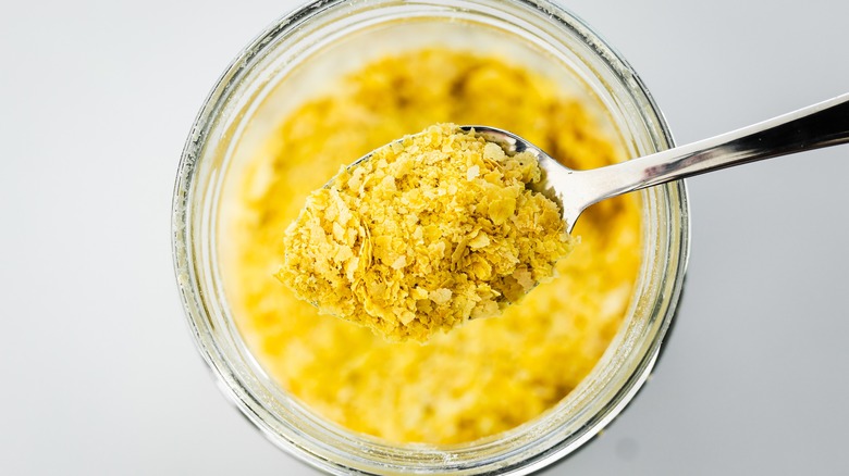 spoonful of nutritional yeast over a jar