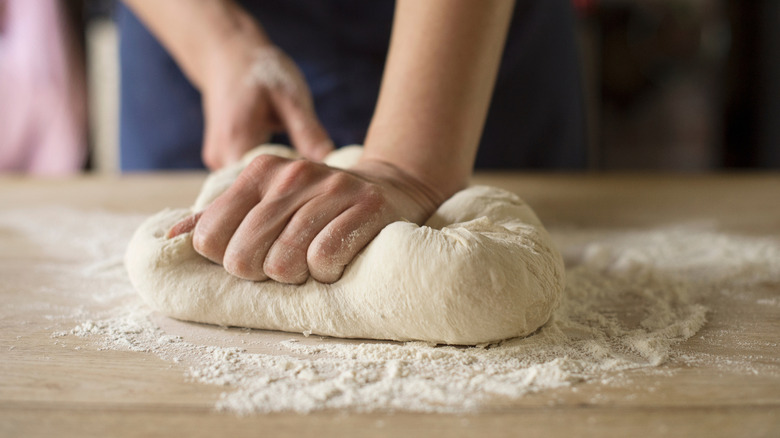 kneading dough with hands