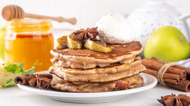 Apple and cinnamon pancakes with ice cream.