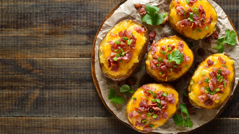 Loaded baked potatoes with cheese, bacon, and chives