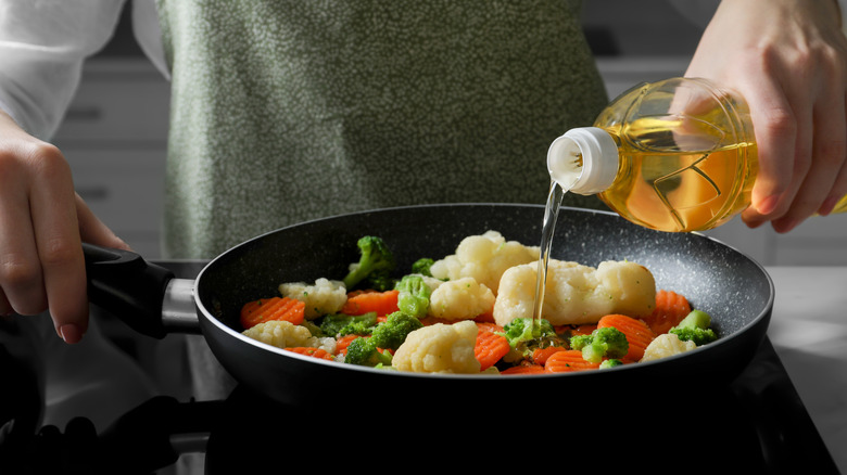 pouring oil into a pan