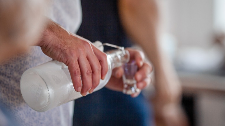 Pouring vodka into a shot glass