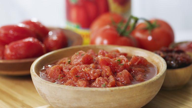 Wooden bowl of canned tomatoes