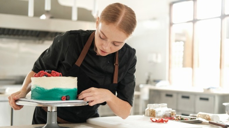 Baker decorating a cake