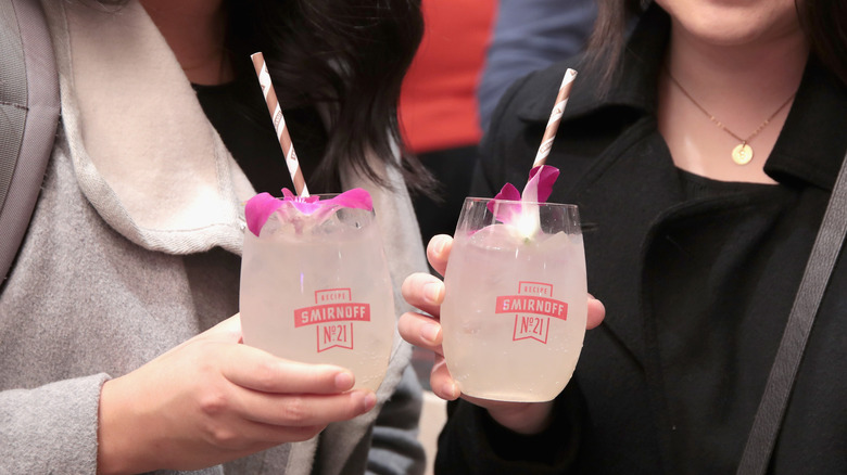 people holding Moscow mules in Smirnoff glasses