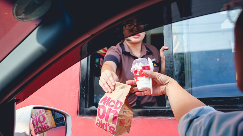 Person takes food from drive thru