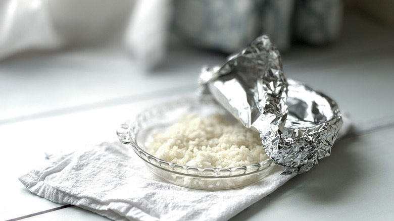 Rice in a glass dish with foil covering