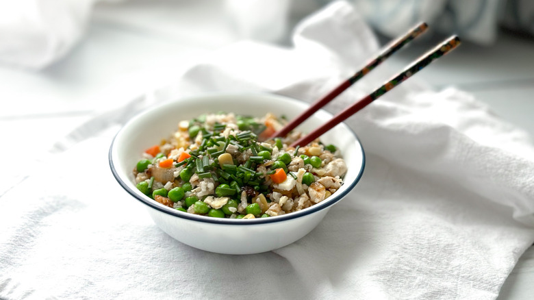 Bowl of fried rice with chopsticks and chives