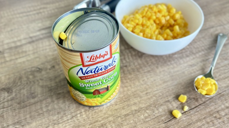 Libby's opened can with corn in bowl and spoon