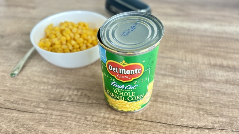 Del Monte can of corn in foreground with corn in bowl