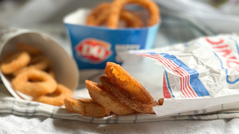 various fast food onion rings resting on towels