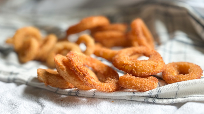 pile of different onion rings on kitchen towels